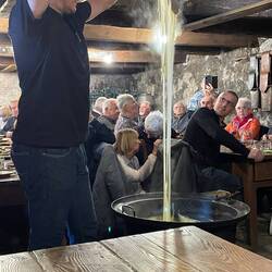 The aligot gets a final stir in front of us before it is served