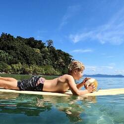 Just a boy chillin out drinking a coconut