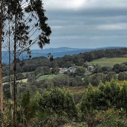 Rolling hills, farmland, and forests stretch out into the distance.
