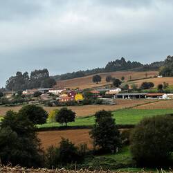 Rolling green fields alternate with plowed soil near Doroña.