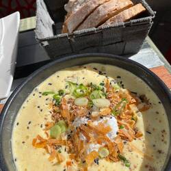 Poached egg, corn emulsion, roasted corn and crispy bacon bits