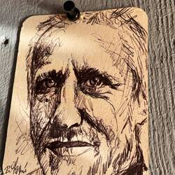 A talented local does sketches of regulars on beer coasters