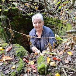 Me in the chimney base searching for the cache without success.