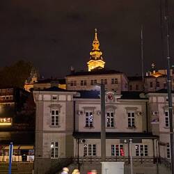 The church steeple stands clearly lit against the night