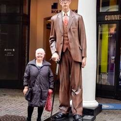 Standing next to a model of the tallest man in the world at 2.72 metres
