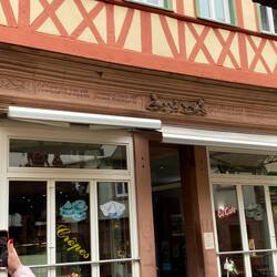 The engraving in sandstone above the door depicts skeletons.