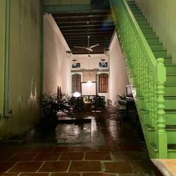 Sitting at the kitchen table, looking towards the front door