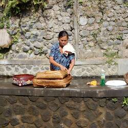 Woman washing her wares at the irrigation channel above Gunong Kawi.