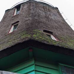 While they have a wooden frame, the walls are made of a straw thatch. Cheap and light insulation.