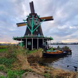 The green scaffolding in the back is on a track used to turn the head of the windmill