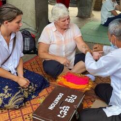 Getting blessed by one of the monks with a bracelet for good fortune