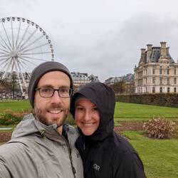 Us in front of the Louvre and Christmas festivities in background