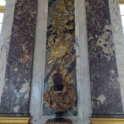A bust in the Hall of Mirrors. Loved the dark red marble and the pattern on the clothing is amazing.