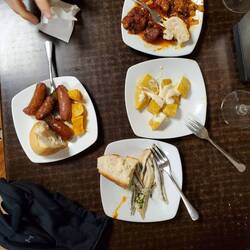 Top puerco Rojo (red pork) right papas bravas (brave potatoes) bottom sardines, left spanish sausage