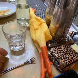 Our meal at Manolin, with Jeff's rubber chicken occupying the counter.