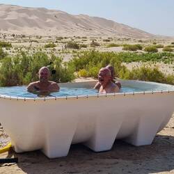 And then, in the middle of nowhere, a bath tub with three men