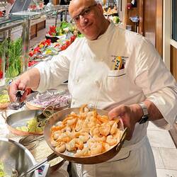 Chef Farid is doing what he does best ... cooking — Aboard Insignia.