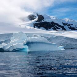 Magnificent Ice Berg with Beautiful Background Mountains
