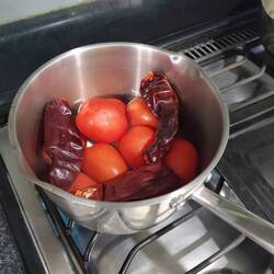 One of many steps- boiling tomatoes and guacillo chiles