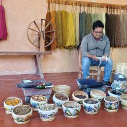 He demonstrated the process of dying and weaving