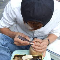 Der junge Mann schneidet Holzstempel