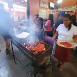 Speeding by the tables of goat heads, pigs' feet and much more carne!