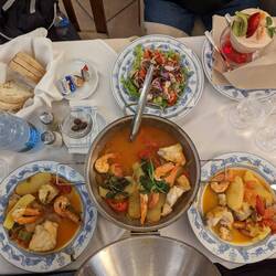 Local dish of Monk Fish w/ Shrimp in Cataplana (bottom). Also pictured is octopus salad (top middle)