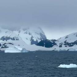 Bergy bits and bergs speeding by — Gerlache Strait, Antarctica.