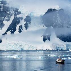 A small vessel provides perspective for the landscape around us — Neumayer Channel.