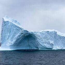 An ice cave is being carved out of the berg — en route to Errera Channel, Antarctica.