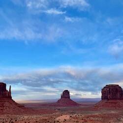 The purple haze of the rocks reflecting in the clouds