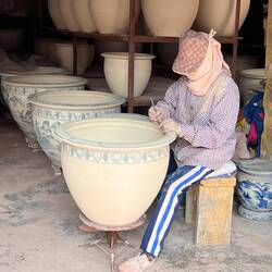 Painting the pots by hand