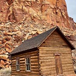 The schoolhouse with the rock backdrop