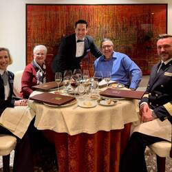 A photo op with our hosts ... for which Alexandru, the Toscana Maitre 'd joins us — Aboard Insignia.