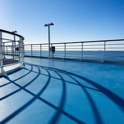 Morning shadows on the Deck 10 jogging track — Aboard Insignia.