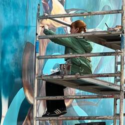 A street artist at work in the STRAAT