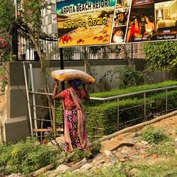 That is a bag of cement she is carrying on her head!