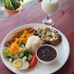 Casado (Reis, Bohnen, Salat, Kochbanane und Fleisch nach Wahl) und ein Guanabana-Saft