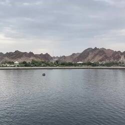 The Hajar Mountains serve as a backdrop to the city — Muscat, Oman.