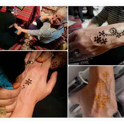 Getting a henna tattoo (the tattoo, once I washed off the henna, is darker than in the last photo).