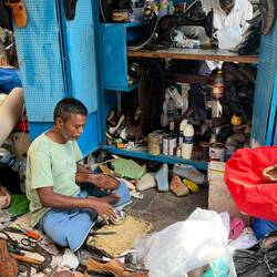 A cobbler on the sidewalk
