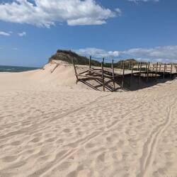 Barren, broken boardwalk. Fell the sand stinging your face!