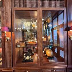 One of three cabinets containing old clocks