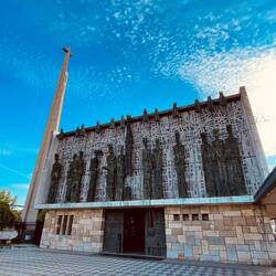 La Virgen del Camino. Modern church but the alter pieta from 13th century.  Lit  by rays of sun.