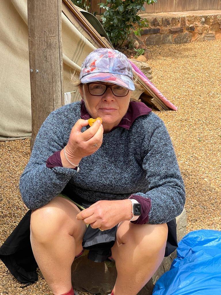 Eating a delicious apricot atop a peak at the pilgrim rest spot