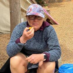 Eating a delicious apricot atop a peak at the pilgrim rest spot