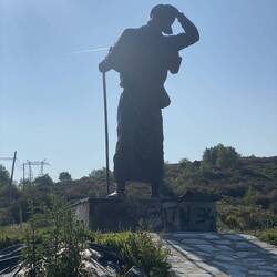 The third highest point of the Camino at 1208 meters. Notice the pilgrim is holding is hat! Wind!