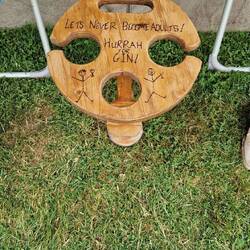 Awesome wine bottle and 2 wine glasses table owned by warden hosts Paul & Sue held up by rebar