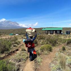 On of the porters who carry all the camping stuff, food, etc up the mountian for the hikers