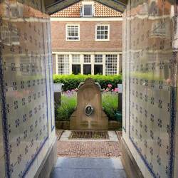 Behind a nondescript door, the entrance to Sint Andrieshofje courtyard!